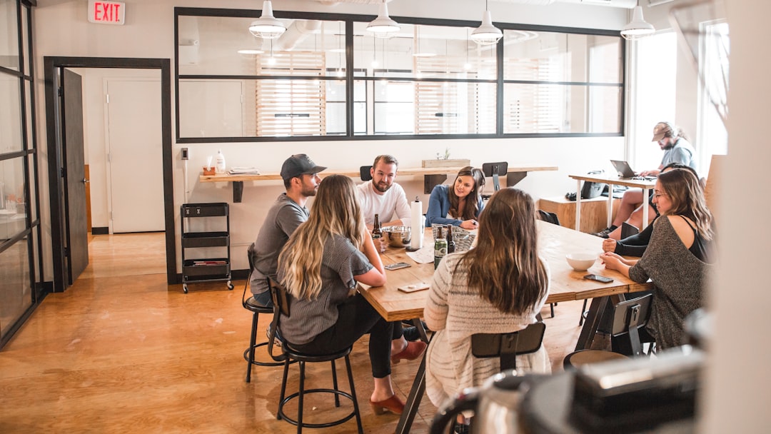 People participating in a collaborative meeting around a table, representing partnership and trust.