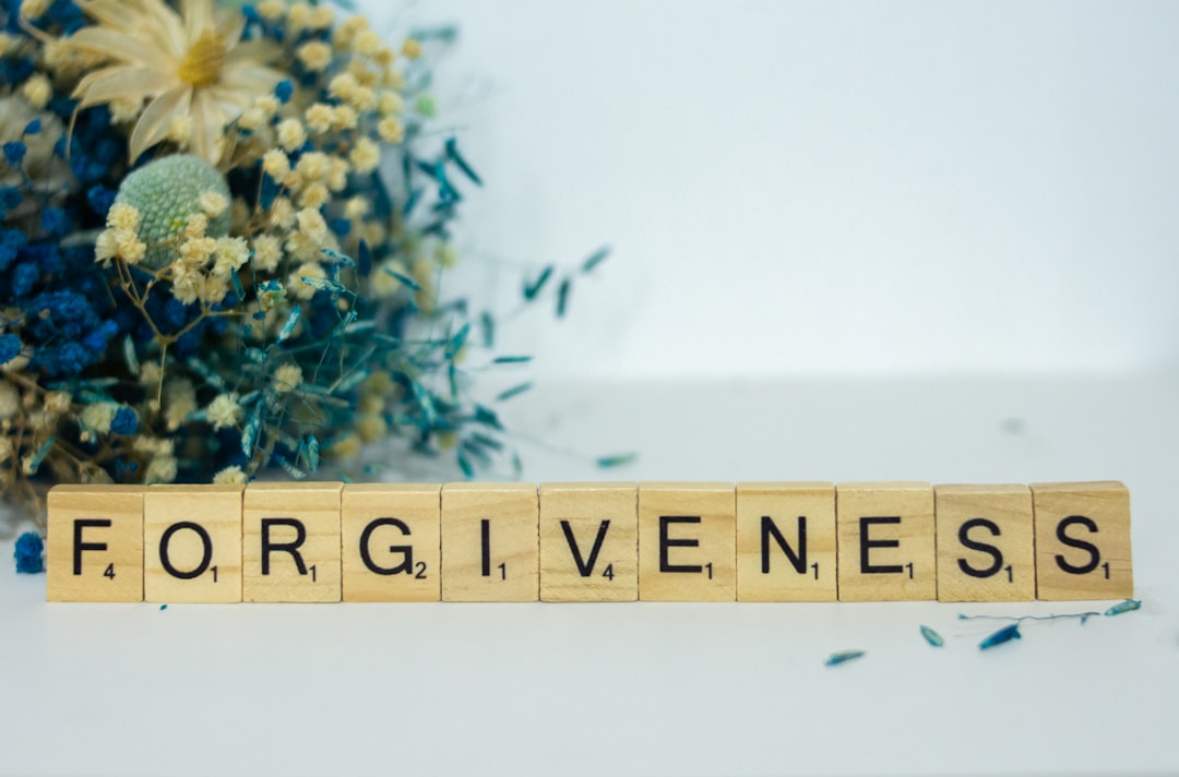 Letter blocks spelling forgiveness, representing reconciliation, healing, and mental freedom