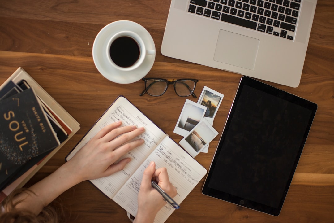 A person writing in a notebook for reflection and journaling.